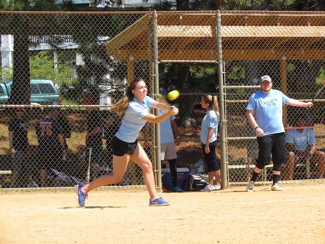 An Unfunded Mandate's player keeps her eye on the ball for a hit.
