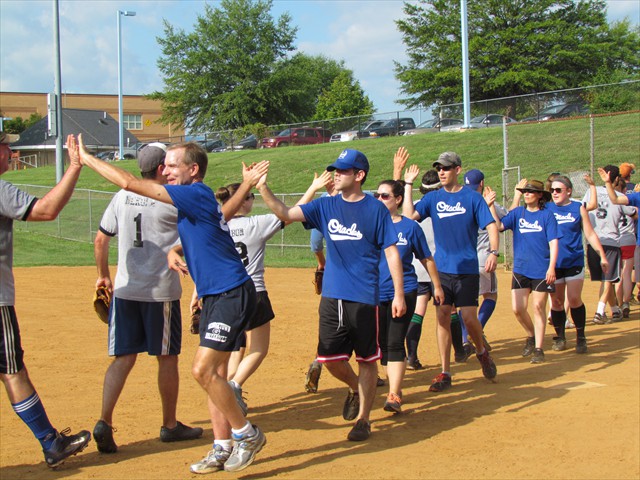 Post-game handshakes demonstrate team sportsmanship.