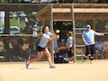 An Unfunded Mandate's player keeps her eye on the ball for a hit.